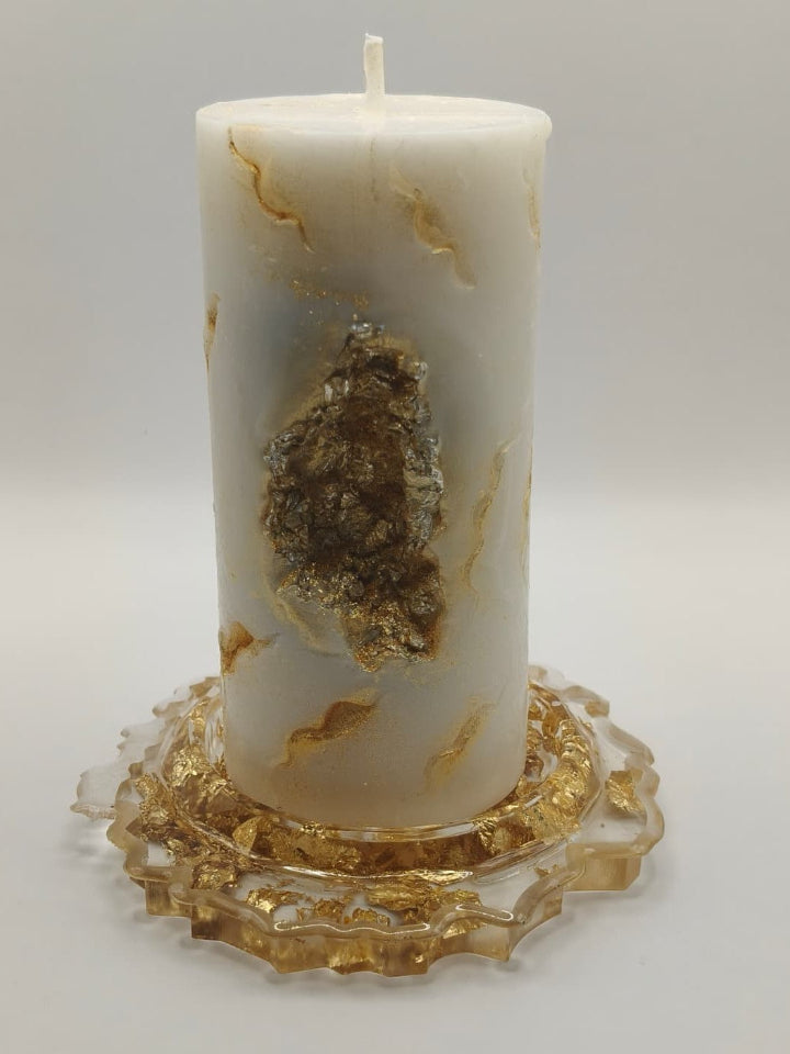 Decorative candle with gold leaf on a white background