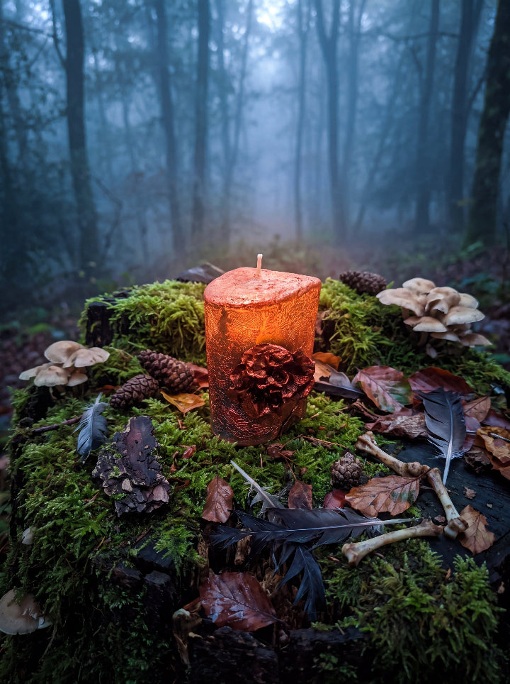 Corrosion bronze candle on moss among autumn leaves, pine cones and mushrooms