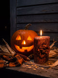 Corrosion bronze beeswax candle burning beside a glowing jack-o'-lantern and dried corn