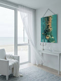 "Culto al Cuerpo" archival pigment print on aluminium hanging in a bright coastal living room with ocean view, white bench and silver candlestick — ConelAlma ESP