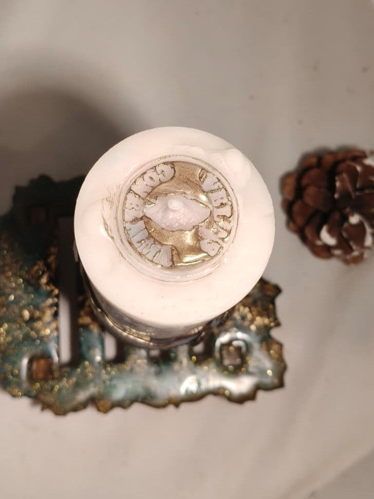 Top view of the decorative ConelAlma wax seal surrounding the wick of the Break the Seal beeswax candle.