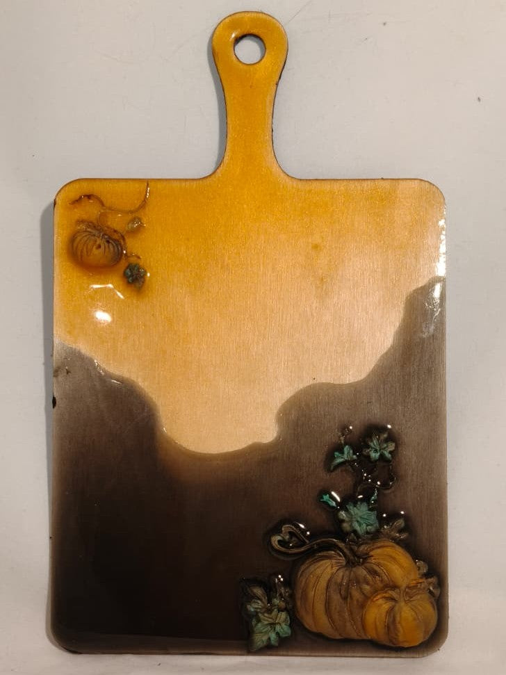 Full view of Salem Board with amber and dark resin, raised pumpkins and a hanging handle