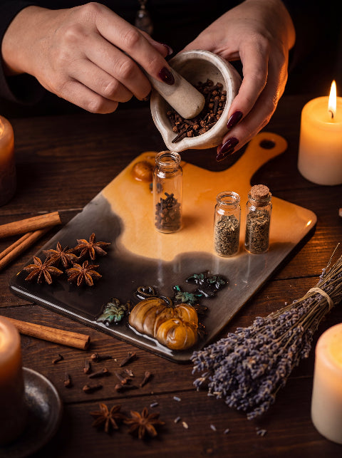 Salem Board with jars of herbs and spices beside candles and lavender