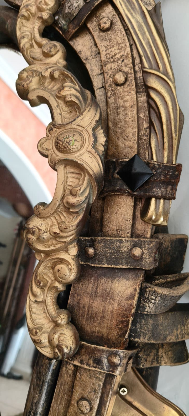 Romanian decorative mirror — lower section with horse harness hardware and original surface texture
