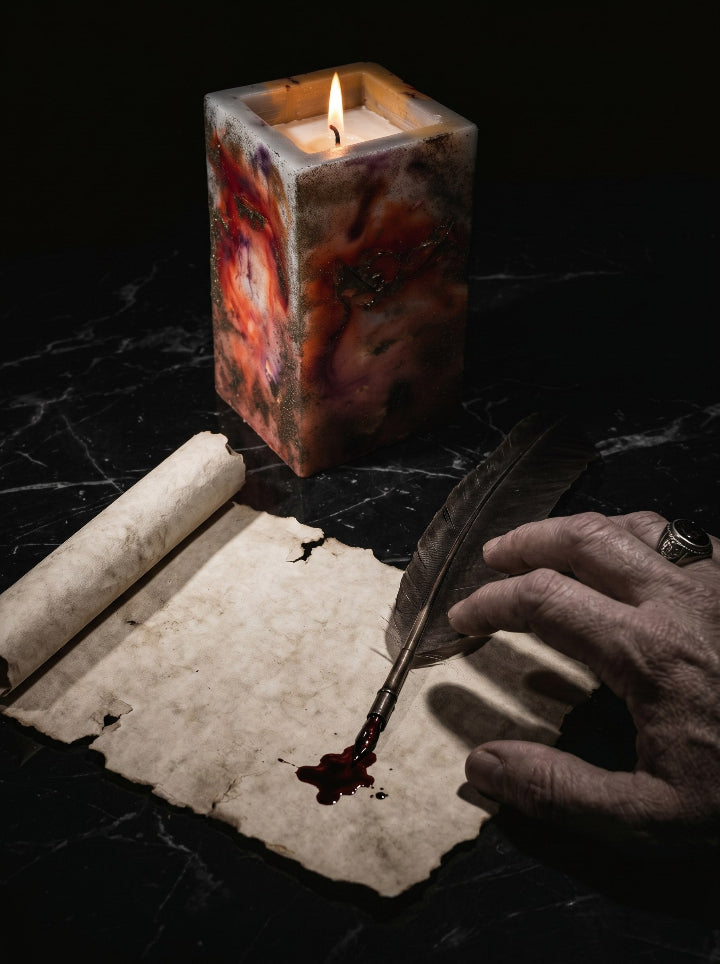 Catharsis candle close-up – Pompeian Red resin art stand with glowing flame