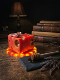 "Bee's Relic" beeswax candle on LED resin stand glowing in the dark, with amber crystals and antique key, ConelAlma ESP